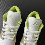 Pair of low-top sneakers with white heel panels and neon green interior