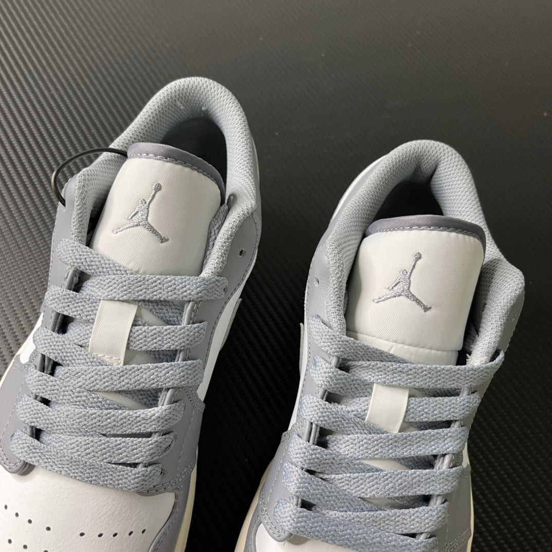 Low-top sneakers pair, light gray tongues with white heel tabs and Jordan logo