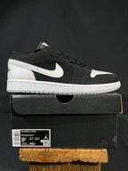 Black and white low-top sneakers with Nike swoosh and lace-up front on shoebox