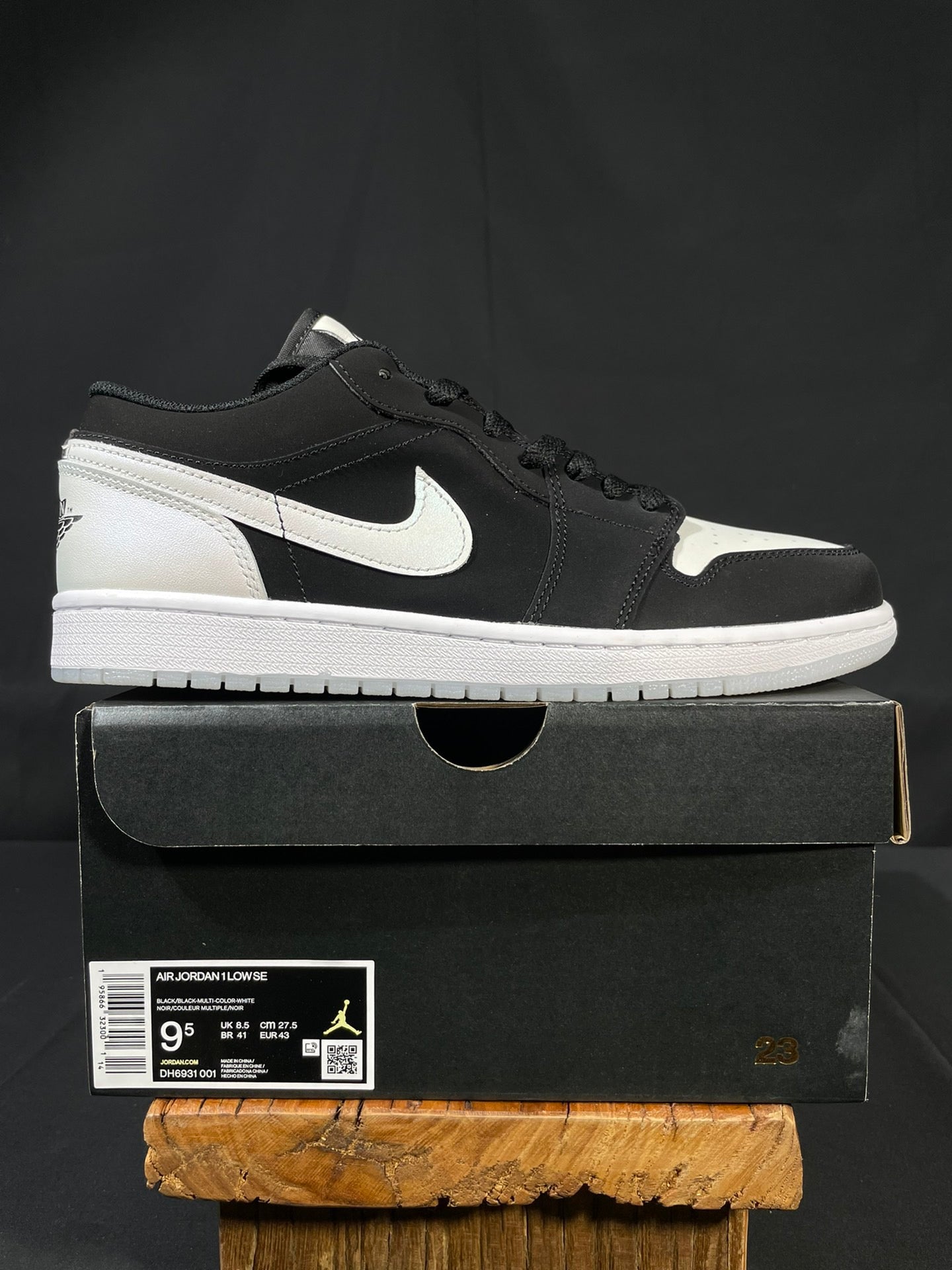 Black and white low-top sneakers with Nike swoosh and lace-up front on shoebox
