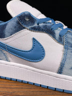 Air Jordan 1 Low sneaker close-up of blue Swoosh and denim-washed overlays