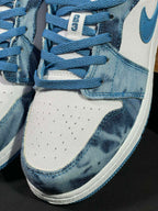 Air Jordan 1 Low sneaker close-up of laces, denim collar, and stitching