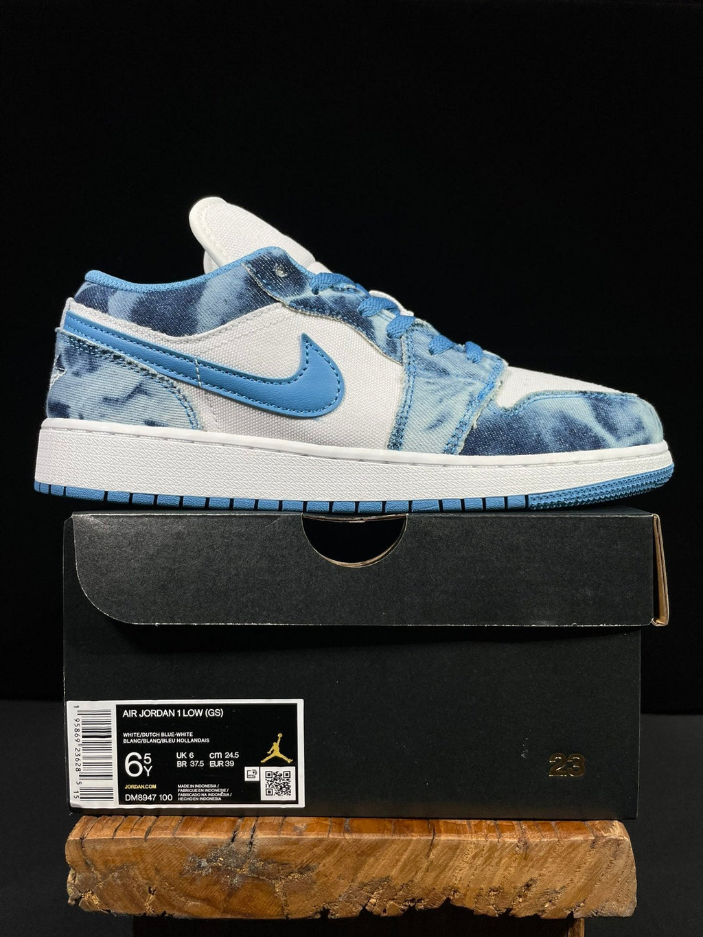 Air Jordan 1 Low sneaker on a box, white and washed denim blue panels