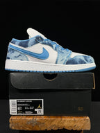 Air Jordan 1 Low sneaker on a box, white and washed denim blue panels