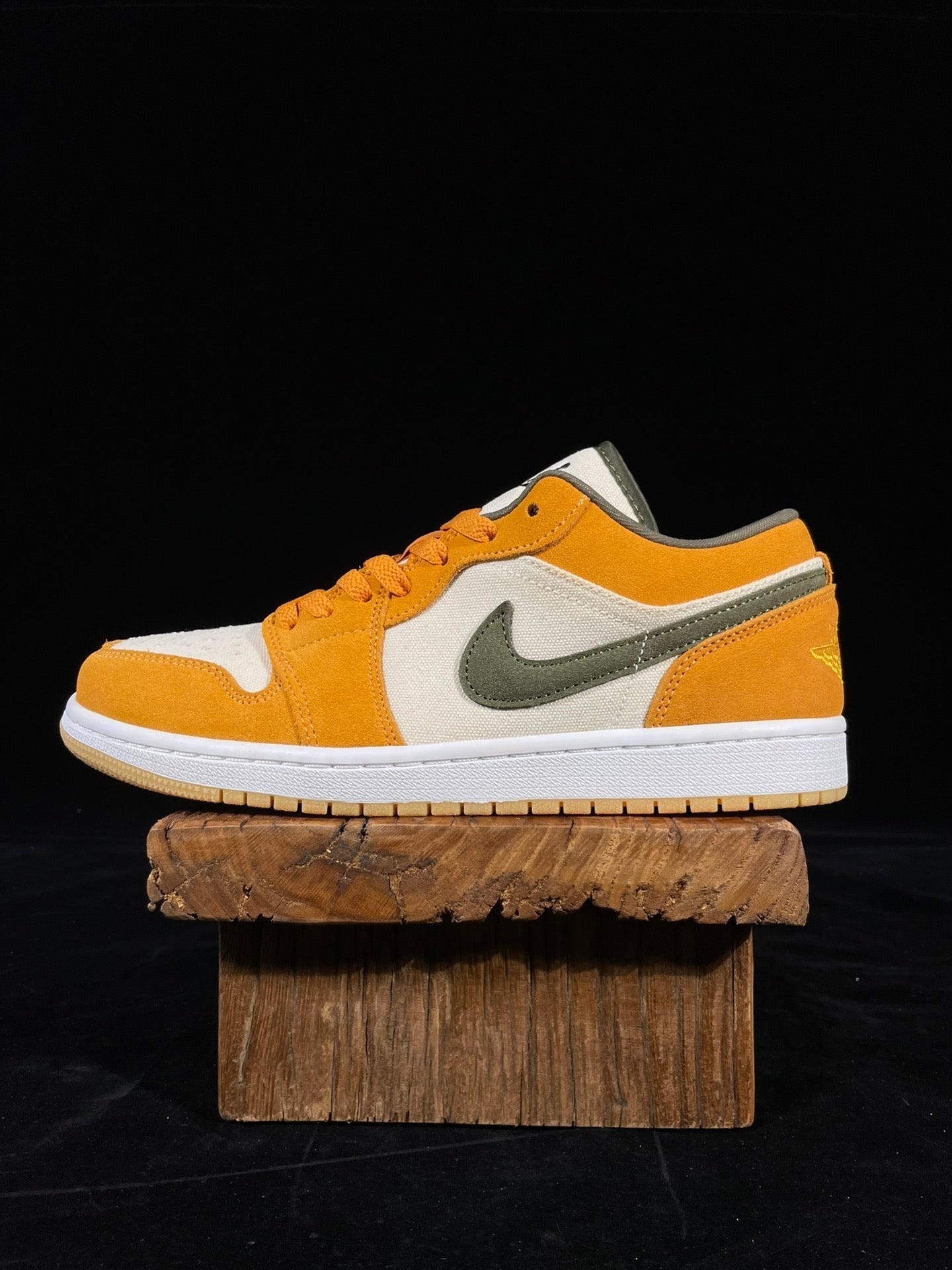 Orange, white and olive low-top sneakers with Nike swoosh; lace-up styling.
