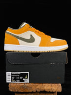 Orange, white and olive low-top sneakers with Nike swoosh, shown with shoebox.