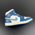 Mid-top sneakers with white base, light blue panels, and blue laces; white midsole.