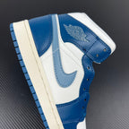 Mid-top sneaker back close-up with blue heel tab and white upper; logo detail on heel.