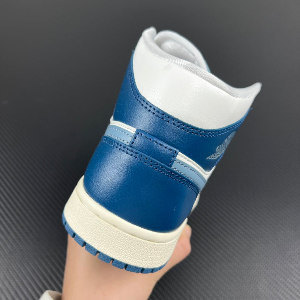 Mid-top sneaker back view with white collar lining, blue heel panel, and padded ankle.