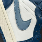 Mid-top sneaker close-up of blue swoosh and laces on a white leather panel.