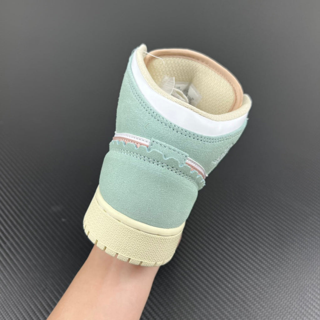 Air Jordan 1 Mid sneaker heel view with mint collar, white lining, and pale yellow platform sole