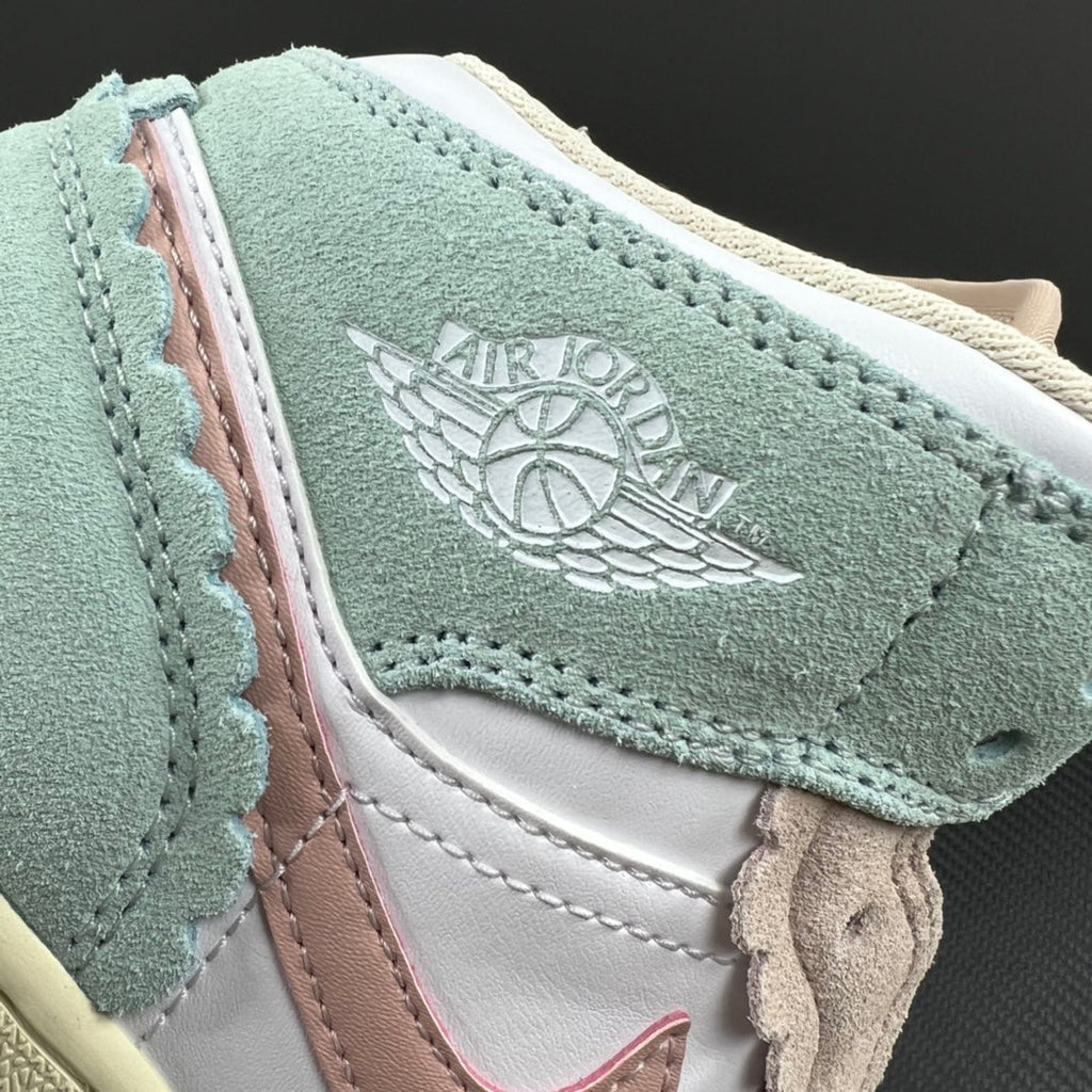 Air Jordan 1 Mid sneaker upper close-up with Air Jordan Wings logo on mint suede