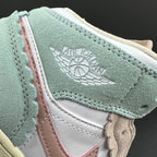 Air Jordan 1 Mid sneaker upper close-up with Air Jordan Wings logo on mint suede