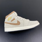 White Air Jordan 1 Mid sneaker with tan swoosh and wing logo