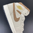White Air Jordan 1 Mid high-top with tan ankle overlay and gold Air Jordan tag