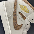 Air Jordan 1 Mid panel close-up with gold wing logo and tan patterned insert