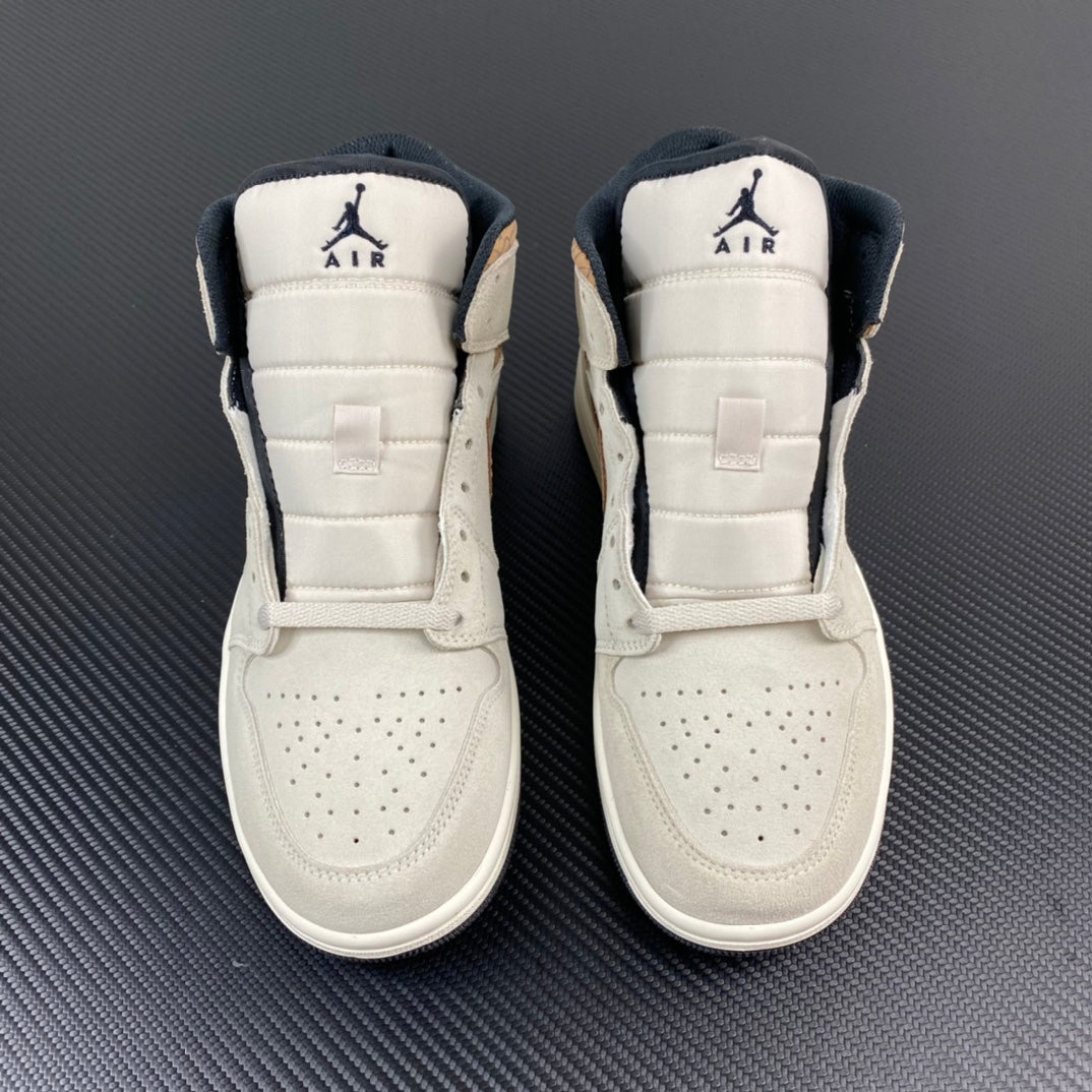 Pair of white Air Jordan 1 Mid sneakers with dark heel Air branding