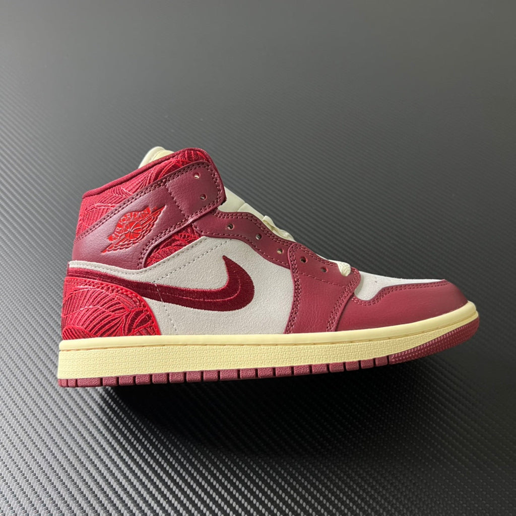 Mid-top sneakers with white panels, burgundy overlays, and red swoosh on beige sole