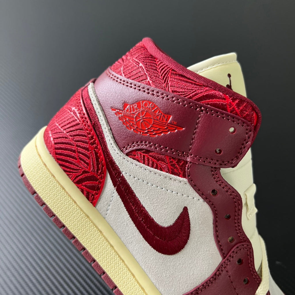 Mid-top sneakers with burgundy ankle strap, white toe panel, and red swoosh design