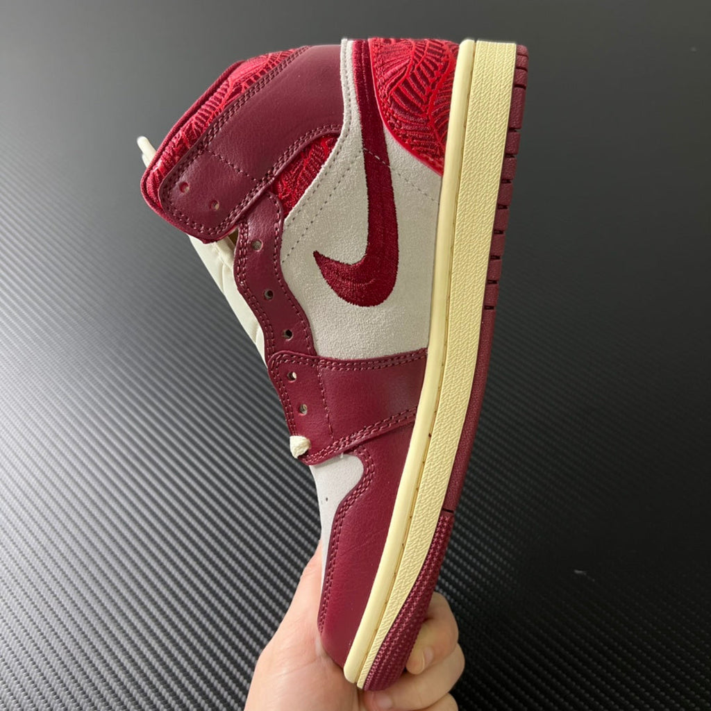 Mid-top sneakers side angle with burgundy leather, white accents, and beige rubber sole