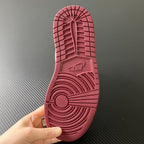 Shoe outsole with burgundy tread pattern and central herringbone-style grip