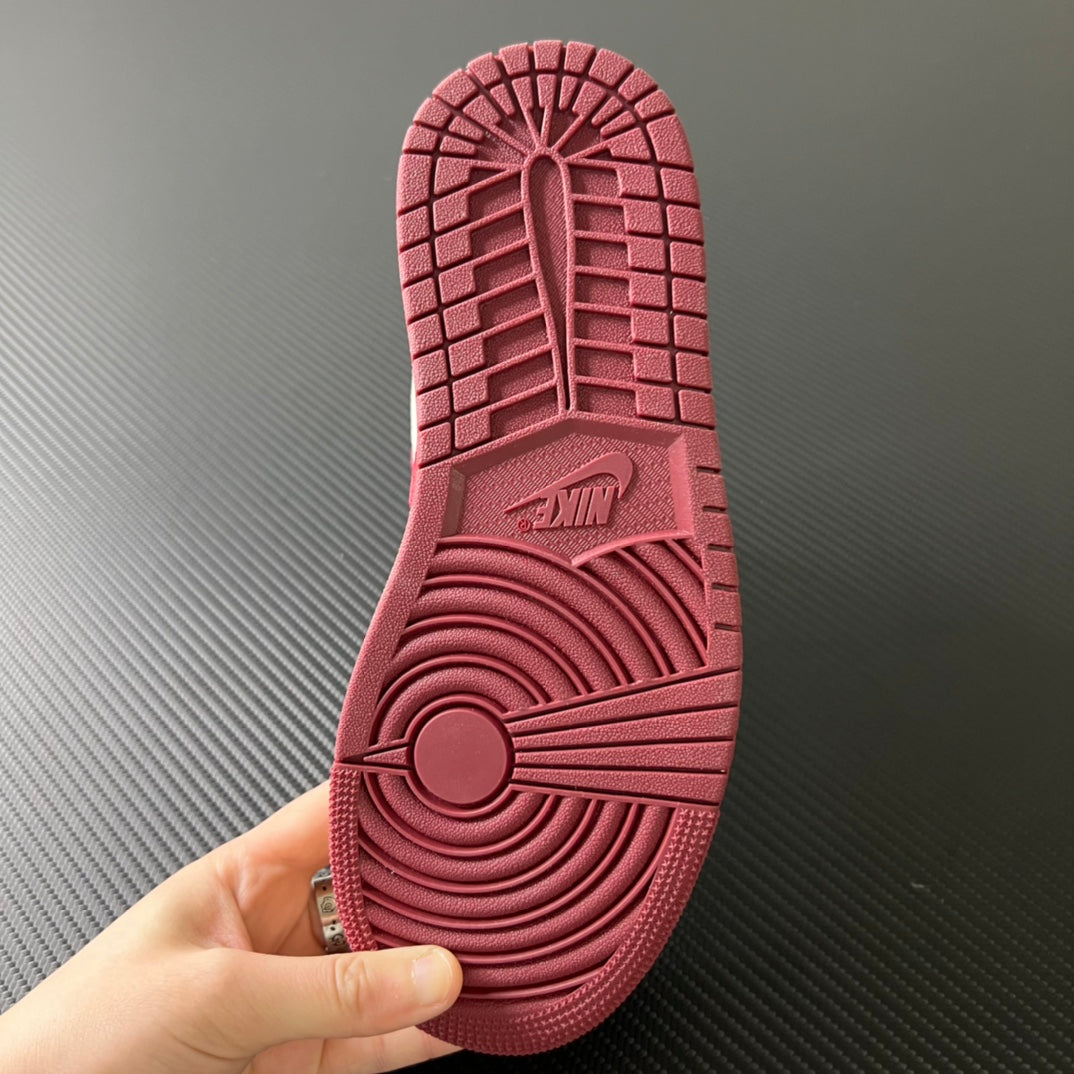 Shoe outsole with burgundy tread pattern and central herringbone-style grip