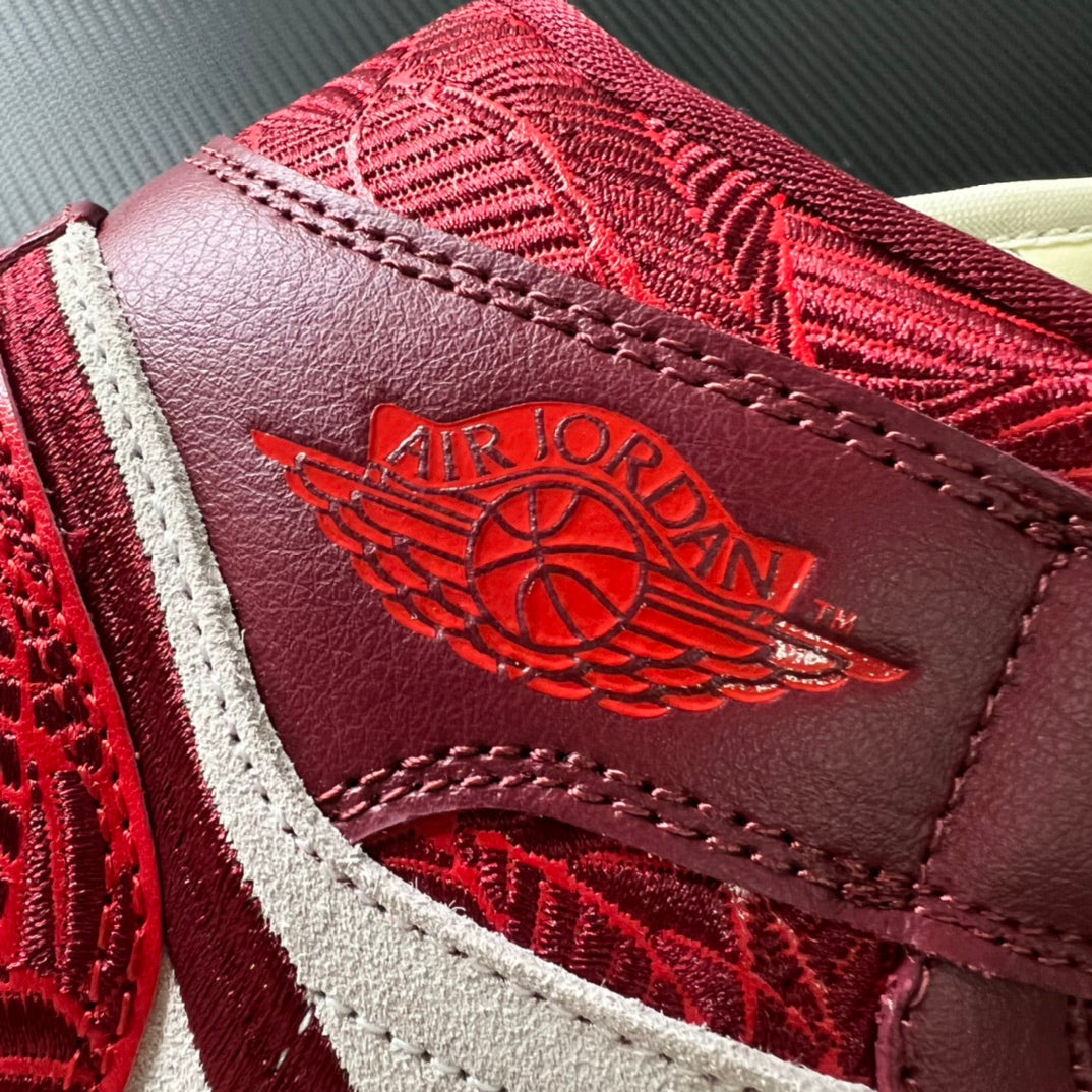 Close-up of burgundy leather heel patch with AIR JORDAN wing emblem and red texture