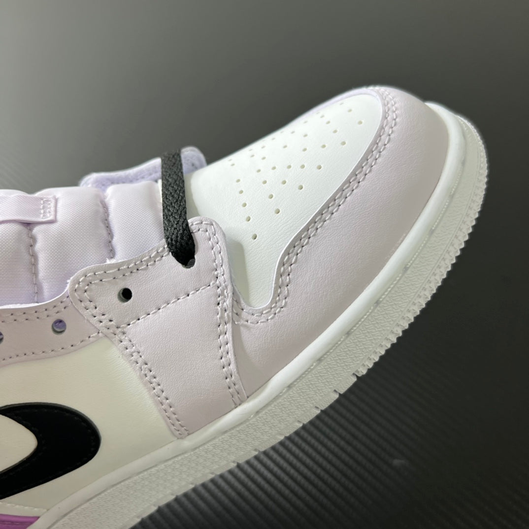 Air Jordan 1 Mid sneaker toe and lace area, white leather with perforations and stitched panels