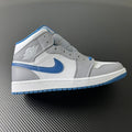 Mid-top leather sneaker with white upper, blue swoosh, and blue outsole