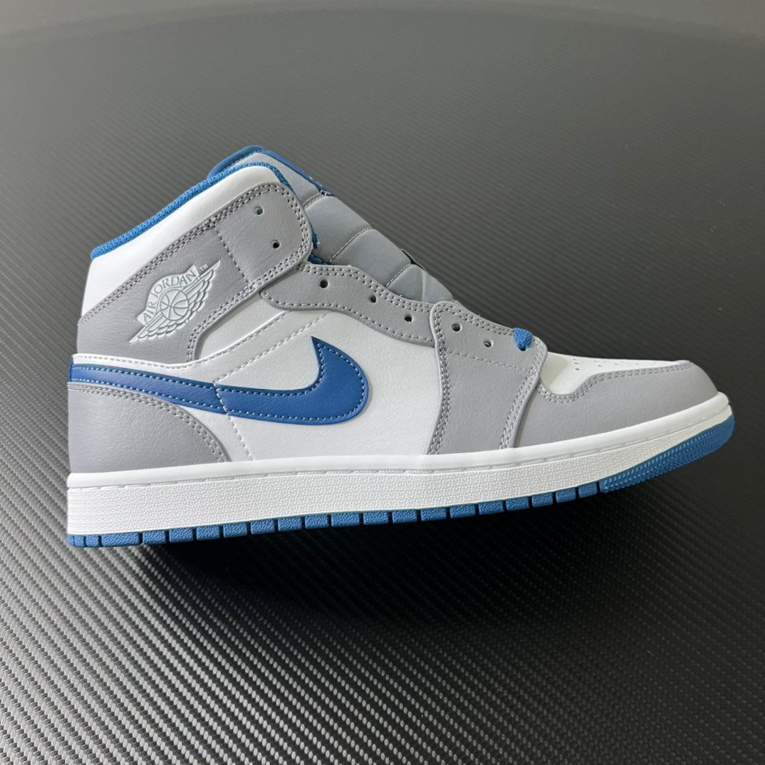 Mid-top leather sneaker with white upper, blue swoosh, and blue outsole