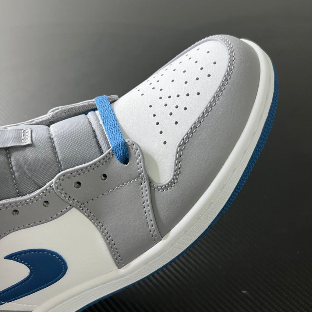Mid-top sneaker quarter view with white leather panels and blue lace trim