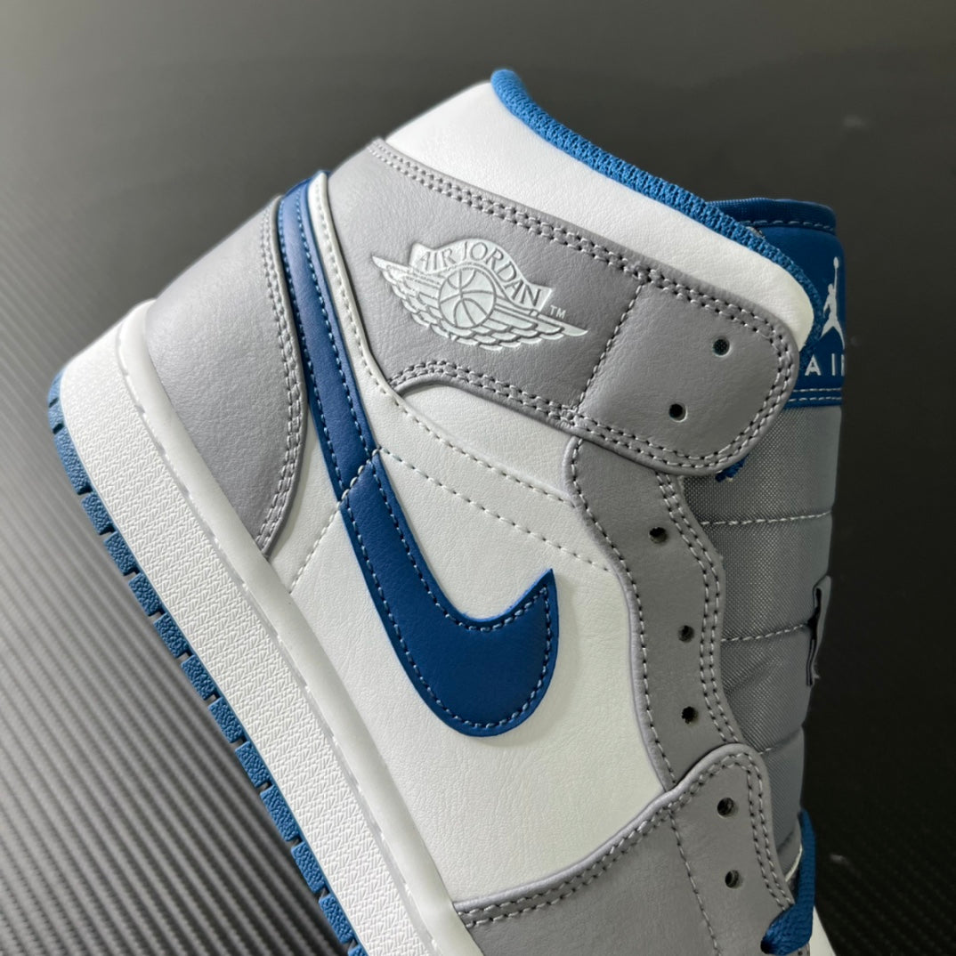 Mid-top sneaker side view with wing logo patch and blue swoosh accents