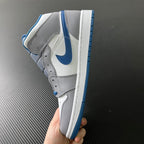 Mid-top sneaker heel view with blue collar lining and white midsole