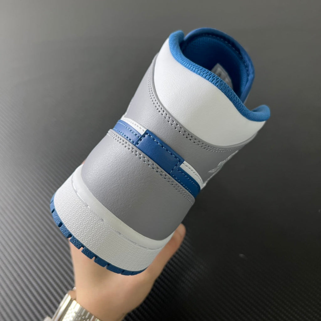 Mid-top sneaker heel with white leather, blue collar lining, and blue side stripe