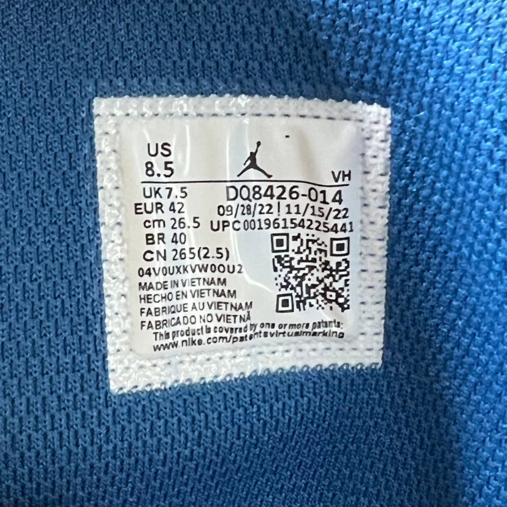 Inside sneaker size label tag with US size, product codes, and QR code