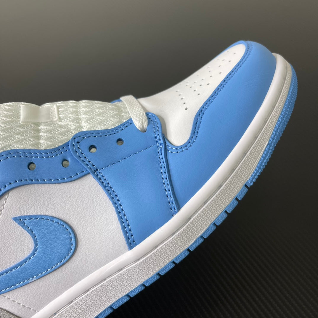 Mid-top sneaker close-up with light blue swoosh on white upper and perforated eyelets.