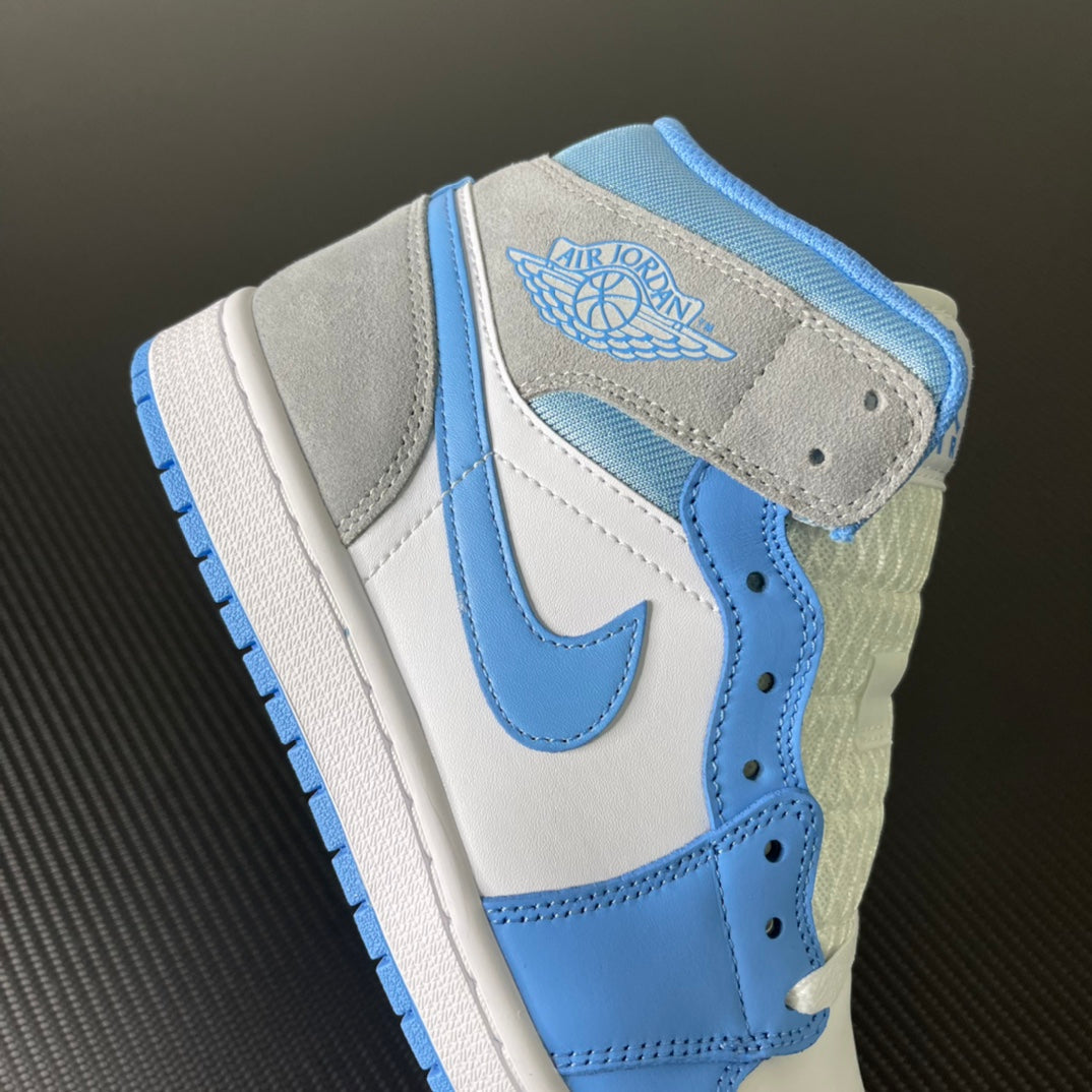 Mid-top sneakers with light blue collar, gray suede heel tab, and Air Jordan wings logo.