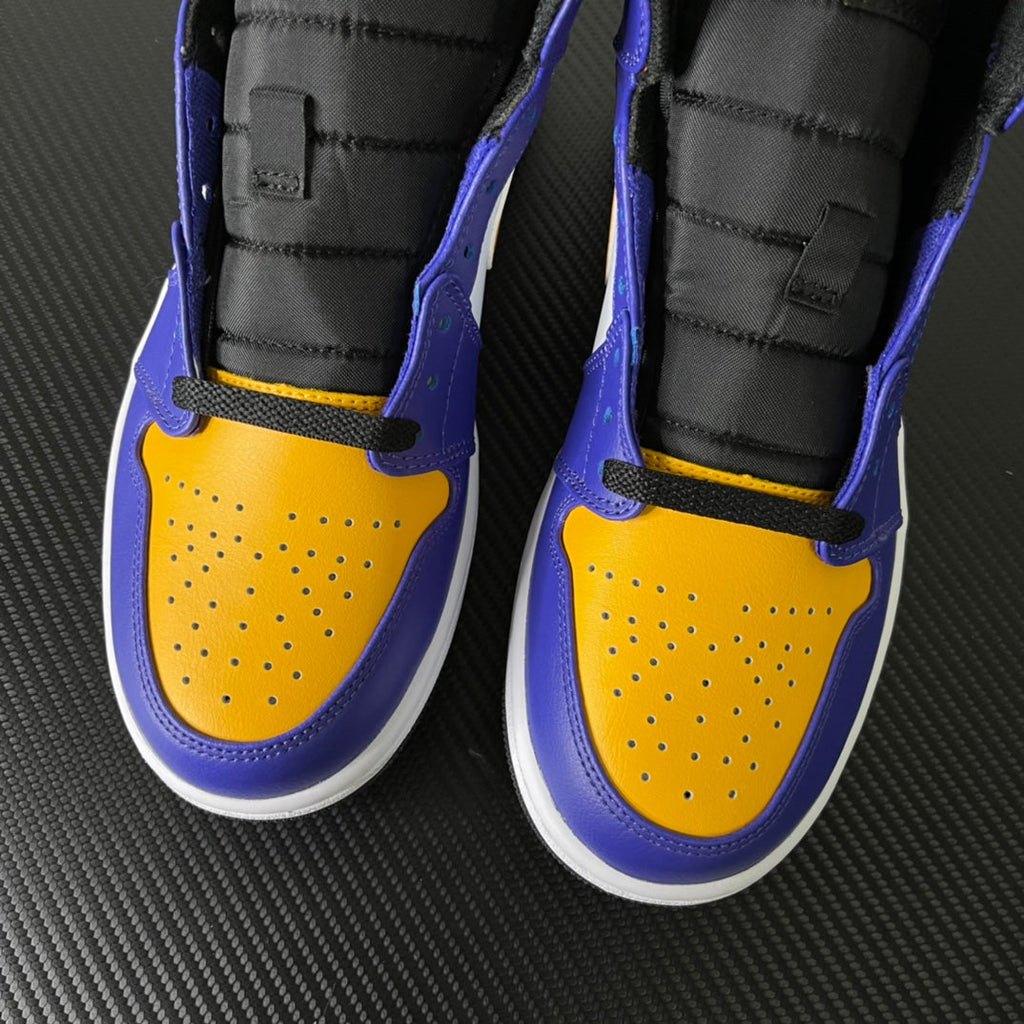 Mid-top sneakers pair front view, purple and yellow perforated toe with white soles
