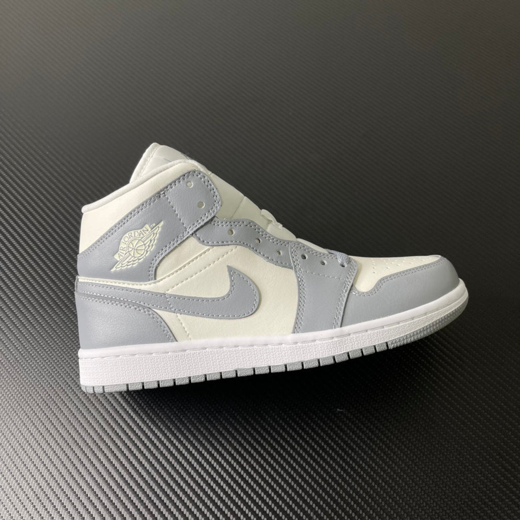 Air Jordan 1 Mid sneaker in sail white with light grey panels and swoosh
