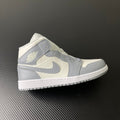 Air Jordan 1 Mid sneaker in sail white with light grey panels and swoosh