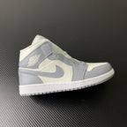 Air Jordan 1 Mid sneaker in sail white with light grey panels and swoosh