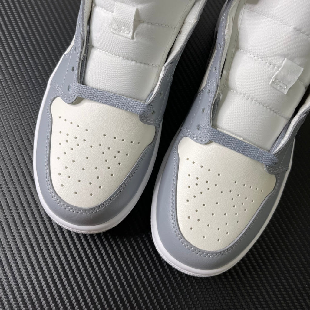 Air Jordan 1 Mid sneaker front view pair with perforated toe and grey edging