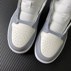 Air Jordan 1 Mid sneaker front view pair with perforated toe and grey edging