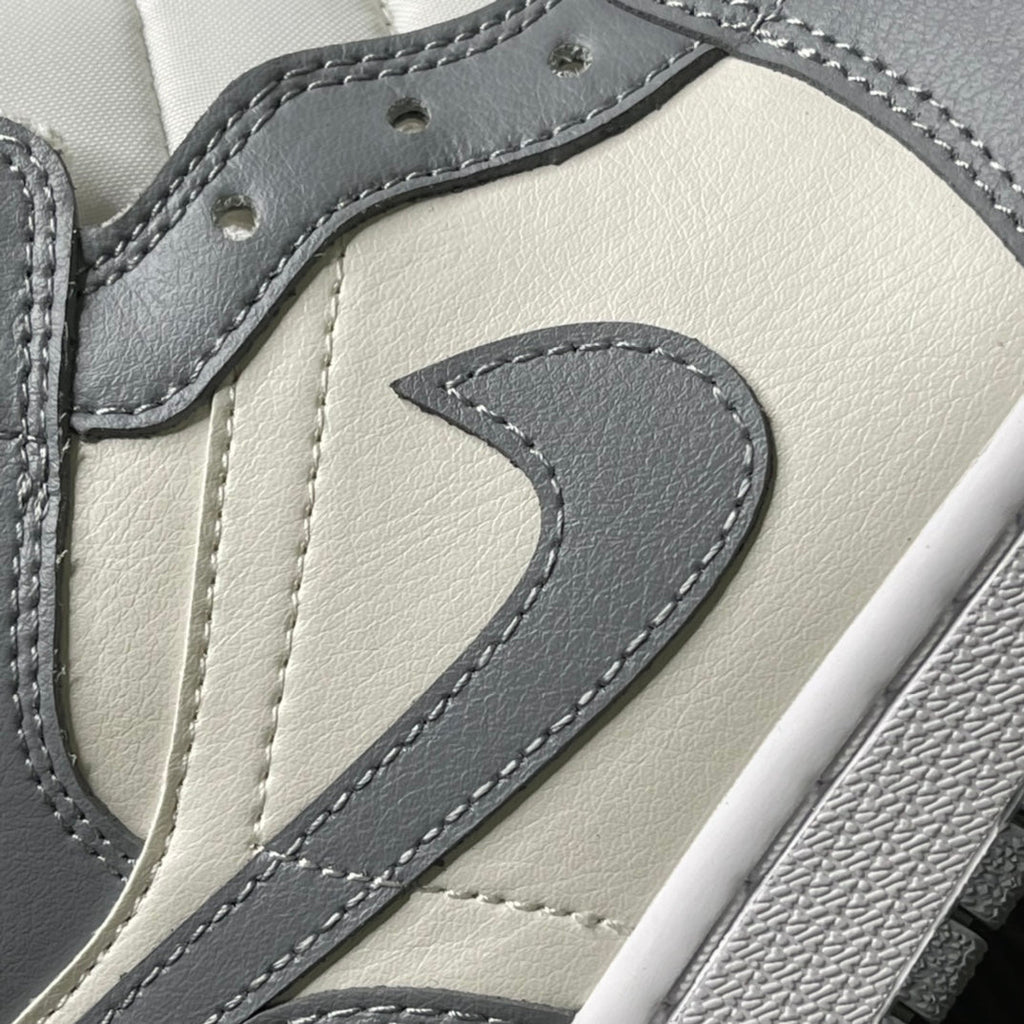 Air Jordan 1 Mid sneaker detail with grey swoosh stitching on sail leather