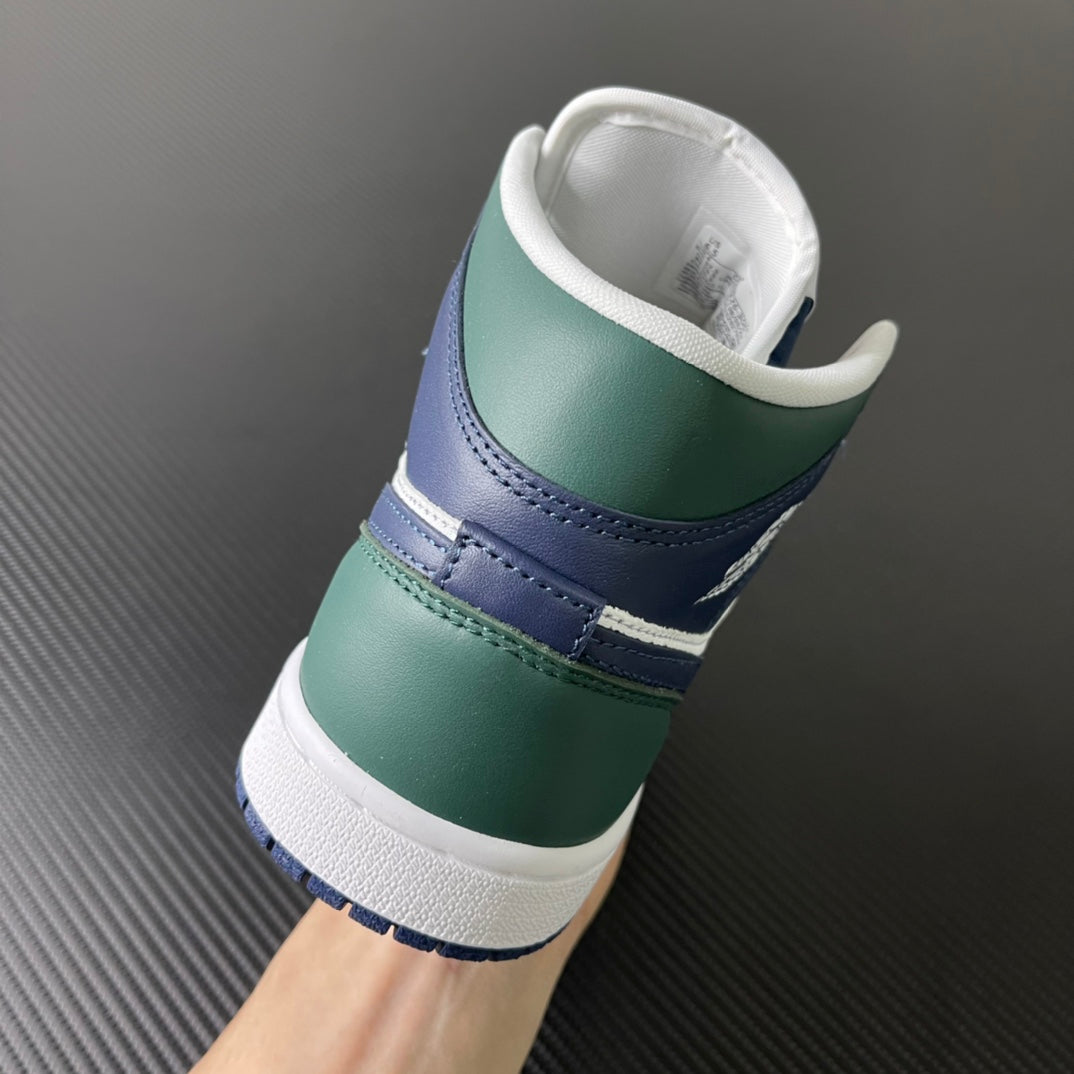 Mid-top sneakers heel view with green leather panels and navy band around the back
