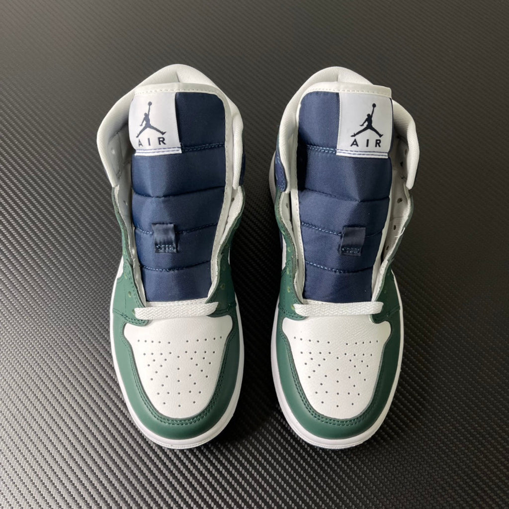 Pair of mid-top sneakers shown from back with green accents and navy padded collar