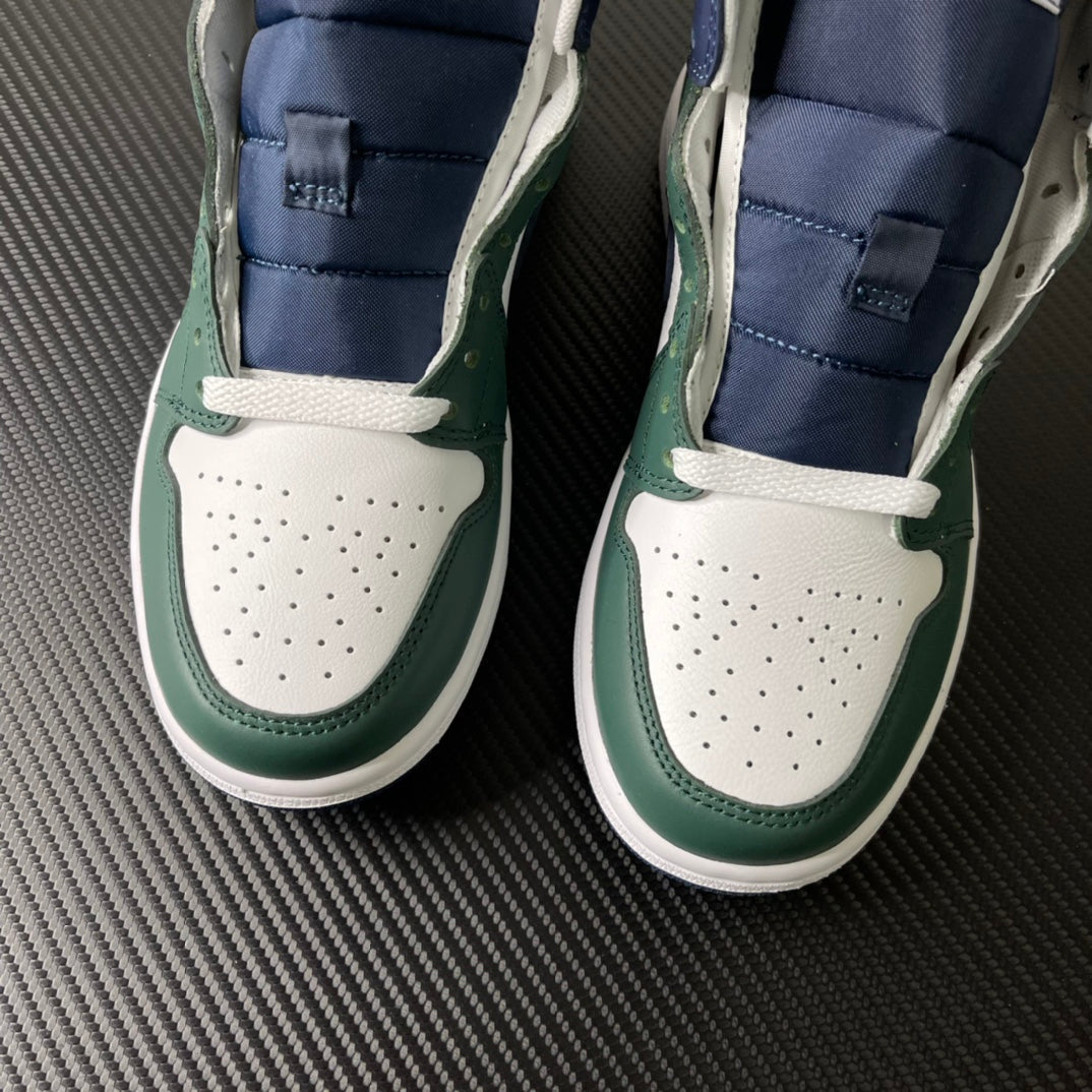 Pair of mid-top sneakers with white perforated toe and green leather side panels