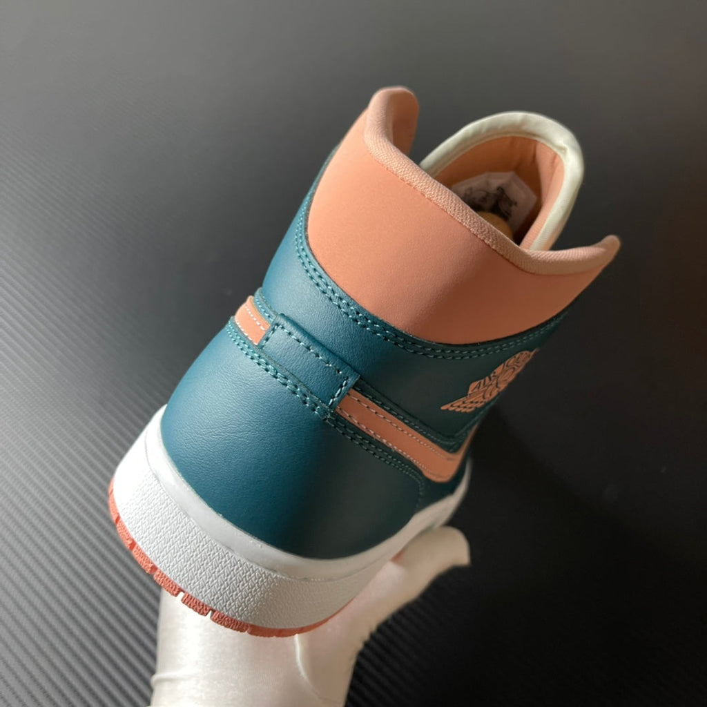 Air Jordan 1 Mid heel and collar view in teal blue with peach lining and white rubber sole.
