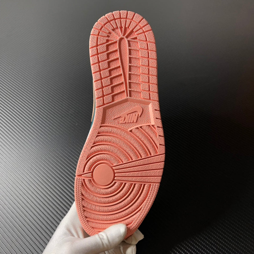 Air Jordan 1 Mid rubber outsole in peach with traction tread and AIR text.