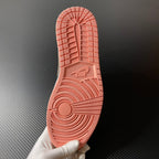 Air Jordan 1 Mid rubber outsole in peach with traction tread and AIR text.